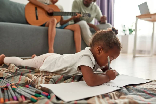 Girl draw while father teach son play on guitar — Stock Photo, Image