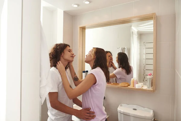 Caring girl touching face of boyfriend in bathroom — Foto de Stock