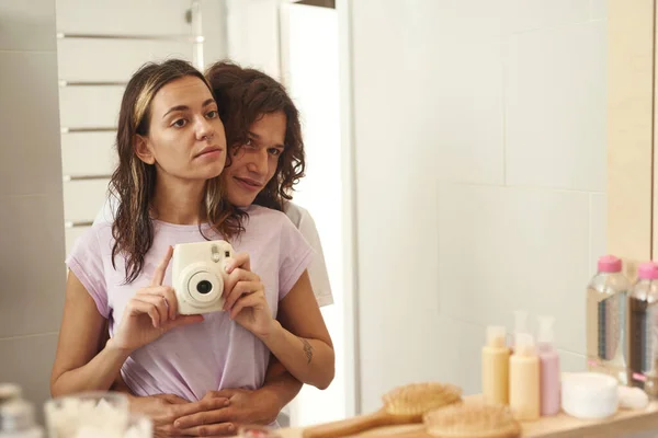 Couple taking photo on digital camera in bathroom — Fotografia de Stock