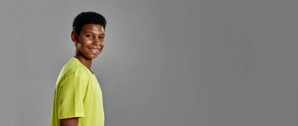 Smiling black boy looking at camera in studio — Stock Photo, Image