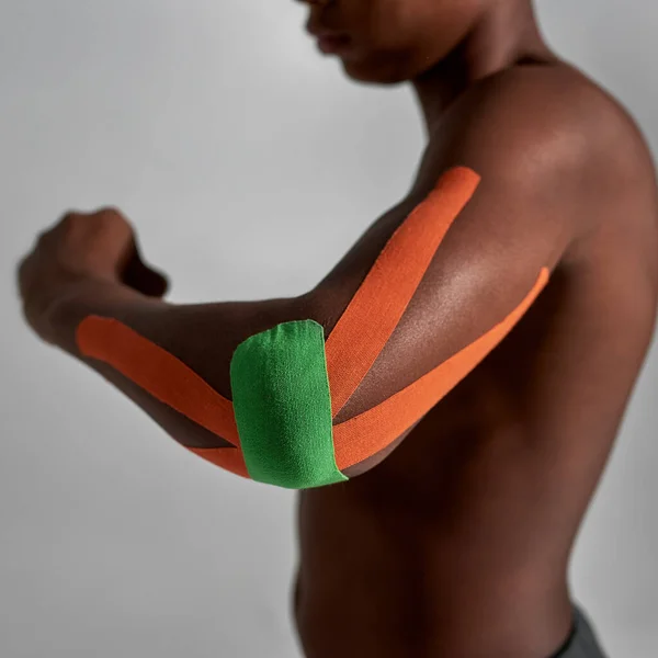 Medical plasters on injured elbow of black boy — Fotografia de Stock