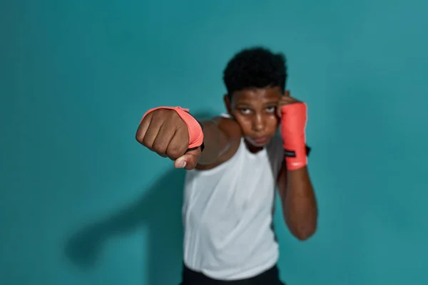 Focus of hitting fist of blurred black boy boxer — ストック写真
