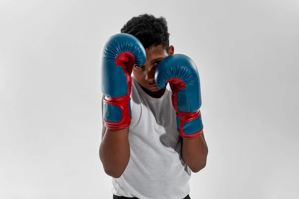 Front view of serious black boy boxer boxing — ストック写真