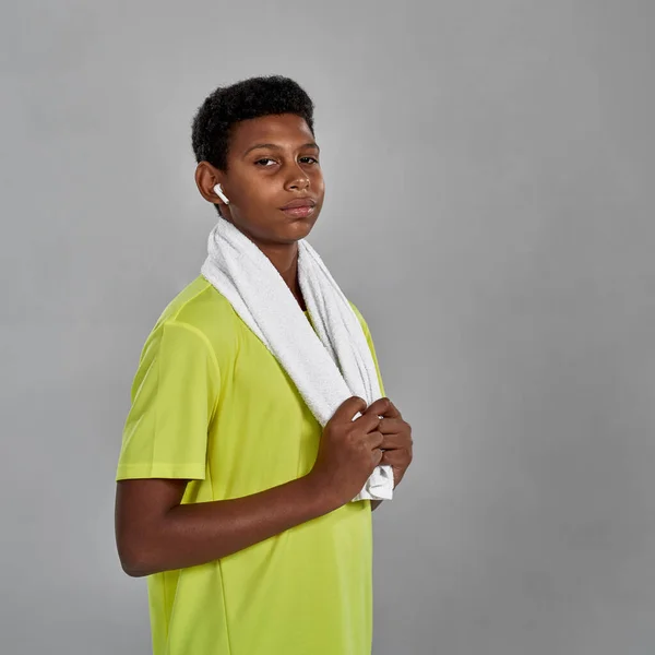 Athletic black boy with towel looking at camera — Fotografia de Stock