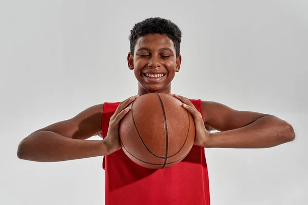 Smiling black boy holding and looking at ball — Stok Foto