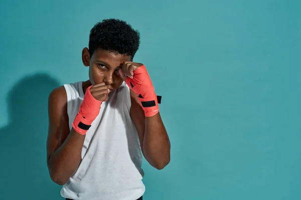 Cropped image of confident black boy boxer boxing