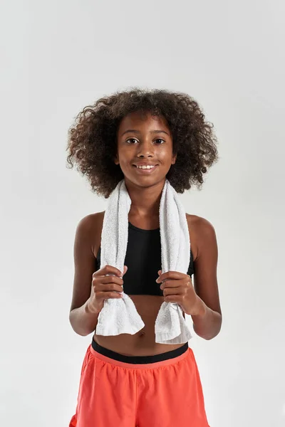 Curly smiling girl with towel looking at camera — Stok fotoğraf