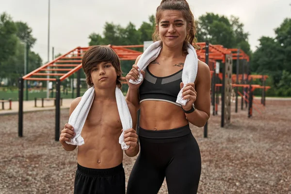 Caucasian mother and son together on sports ground — Stok fotoğraf