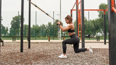 Side view of sportswoman do lunges for ass muscles