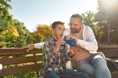 Father give drink water son with cerebral palsy