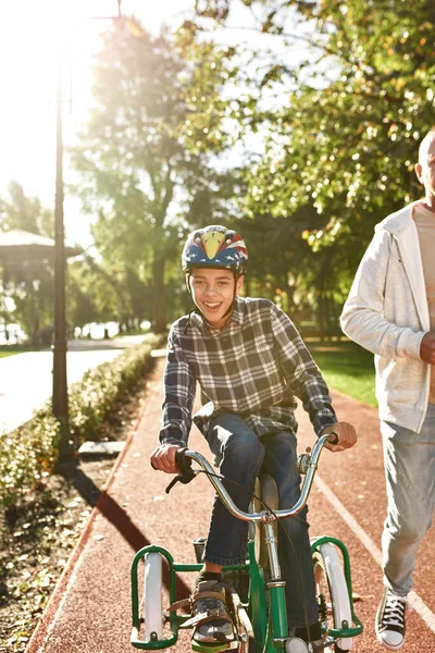 Man jog and boy with disability ride tricucle — Stock Fotó