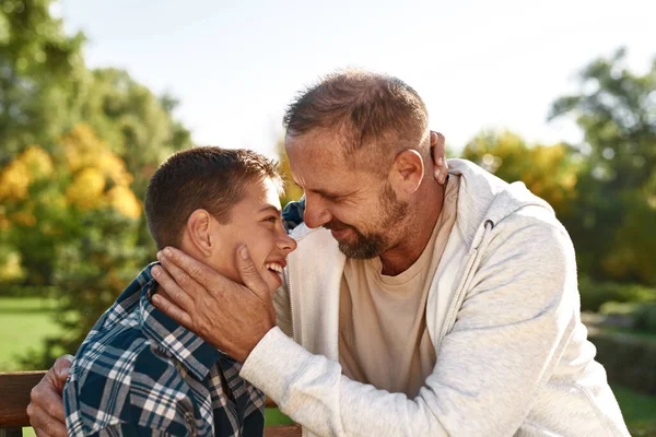 Happy dad and son embrace and look at each other — Stok fotoğraf