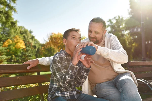 Dad giving drinking water son with cerebral palsy — Stok fotoğraf