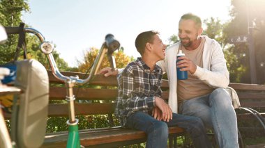 Dad give drinking water son with cerebral palsy