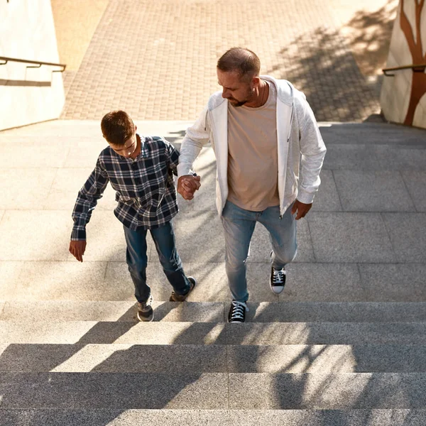 Top view of father and son going up on staircase — Stok fotoğraf