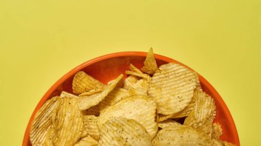 Sarı arkaplanda cips izole edilmiş kase