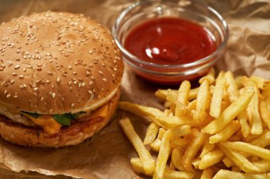 Close up of classic burger, french fries and sauce