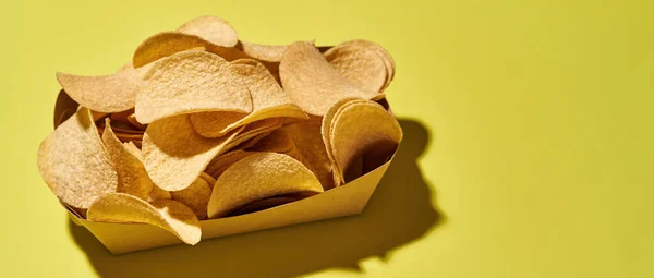 Top view of cardboard box full of potato chips — Stockfoto