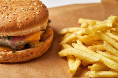 Classic burger and french fries on craft paper