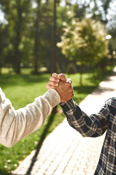 Partial of dad and son with disability shake hands — Zdjęcie stockowe