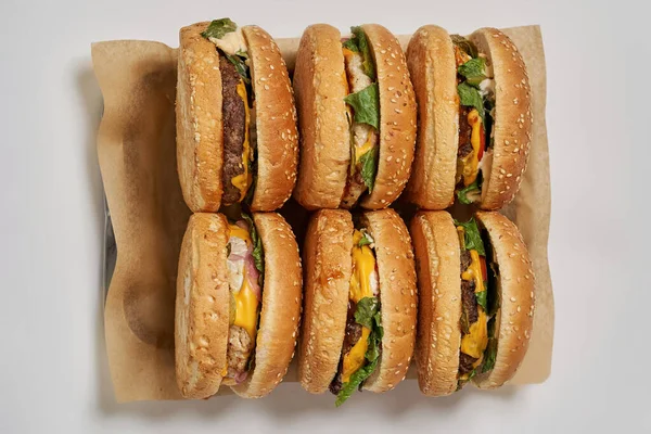 Six burgers on craft recyclable paper in tray — Stok fotoğraf