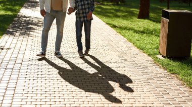 Father and teenage son with cerebral palsy walking