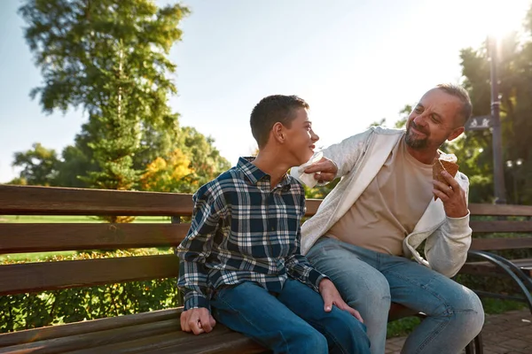 Caucasian father wipe face of son with disability — Stok fotoğraf