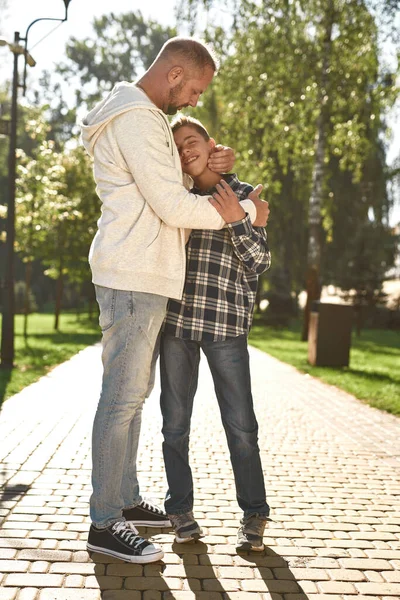 Father hugging enjoying son with cerebral palsy — Stok fotoğraf