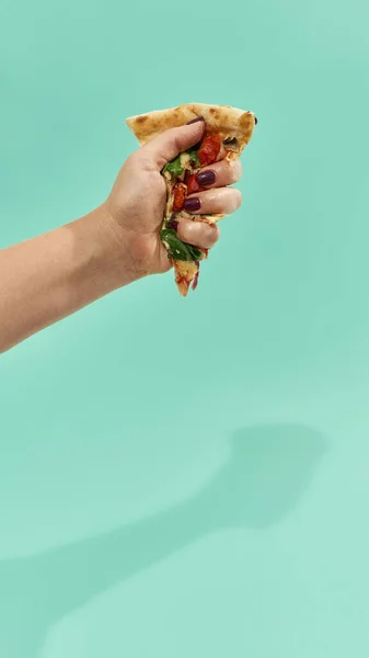 Woman hand squeezing slice of pepperoni pizza — Stock Photo, Image