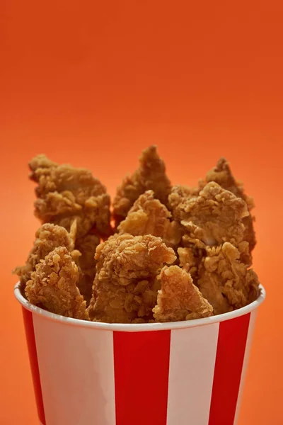 Partial side of bucket with chicken wings and legs