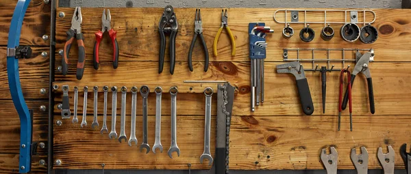 Set of different tools on wooden stand in workshop