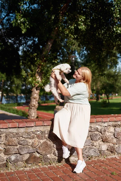 Young Smiling Caucasian Girl Holding Looking Cute Furry Maltese Dog — Stock Photo, Image