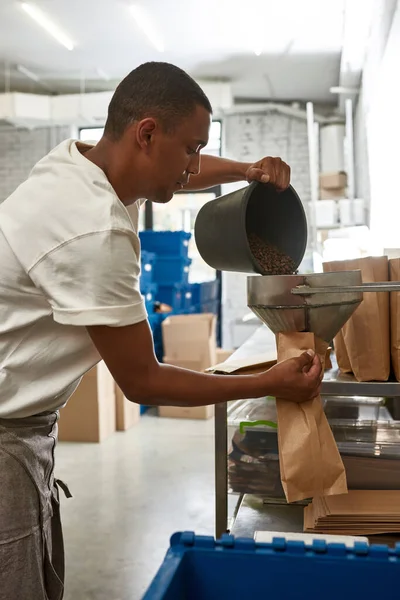 Male Worker Barista Pouring Out Roasted Coffee Beans Bucket Package — ストック写真