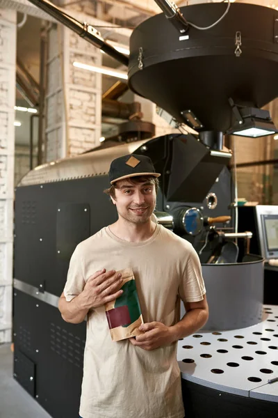 Young Smiling Caucasian Male Barista Worker Holding Coffee Package Industrial — Fotografia de Stock