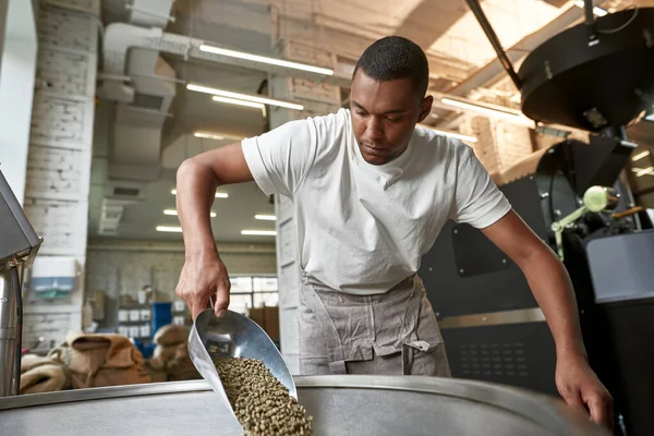 Young Black Male Worker Barista Pouring Out Green Organic Coffee — Fotografia de Stock