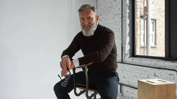 Grey Hair Confident Caucasian Man Sitting Chair Looking Camera Spacious — Foto Stock