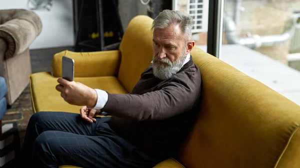 Grey Hair Serious Caucasian Man Taking Selfie Mobile Phone Sofa — Fotografia de Stock