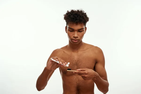 Focused Black Guy Pouring Toothpaste Toothbrush Brushing Teeth Young Brunette — Stock Fotó