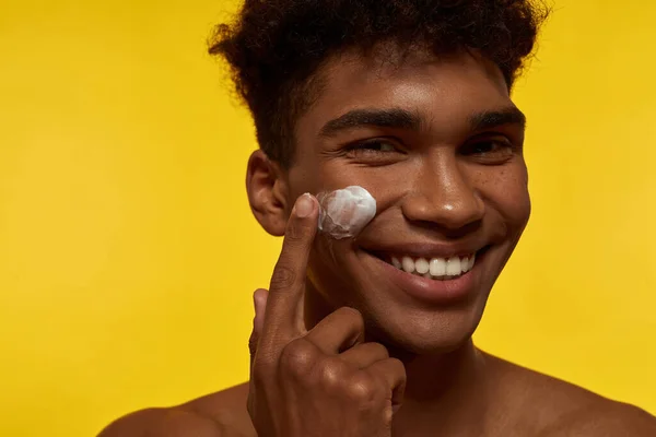 Cropped Smiling Black Guy Smearing Cosmetic Cream His Face Young — Stock Fotó