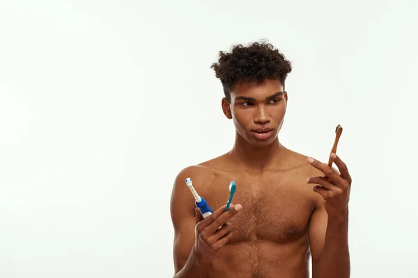 Concentrated Black Guy Looking Toothbrush Three Kinds His Hands Young — Stock Fotó