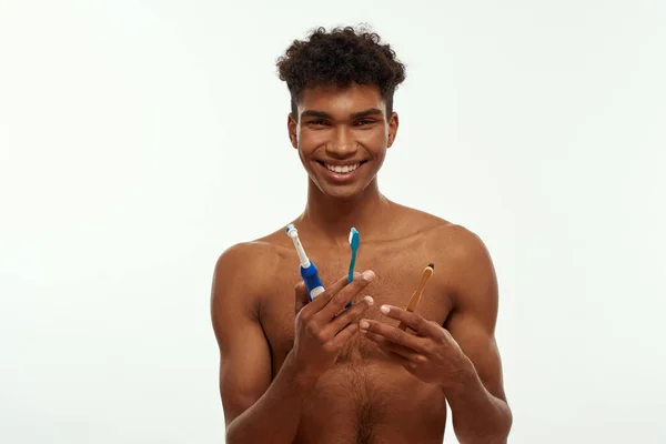 Smiling Black Guy Holding Three Variety Toothbrushes Young Brunette Curly — Fotografia de Stock