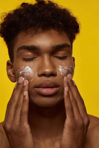 Portrait African American Guy Smearing Cosmetic Cream His Clean Face — Stock Fotó