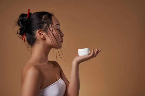 Side View Asian Girl Closed Eyes Holding Container Cosmetic Cream — Stockfoto