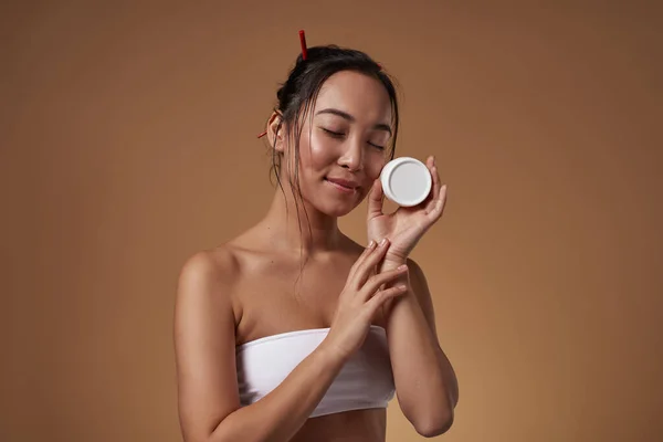 Fashionable Asian Girl Closed Eyes Holding Container Cosmetic Cream Pretty — Stockfoto