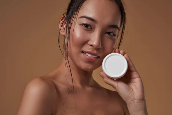 Cropped Fashionable Asian Girl Holding Container Cosmetic Cream Looking Camera — Stockfoto