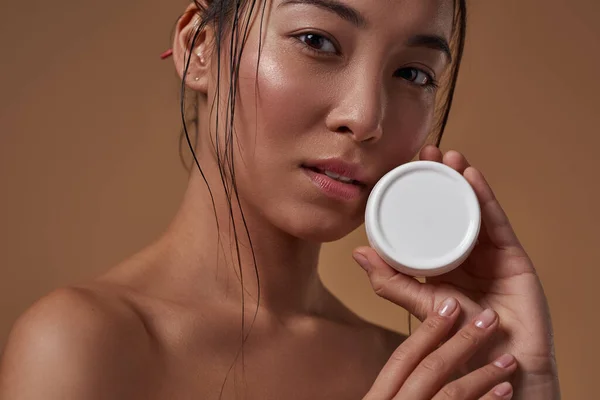 Partial Elegant Asian Girl Holding Container Cosmetic Cream Looking Camera — Stockfoto