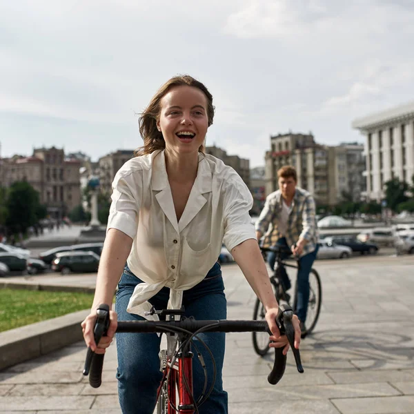 Focus Foreground Excited Girl Her Blurred Boyfriend Background Riding Bicycles — Stock Photo, Image
