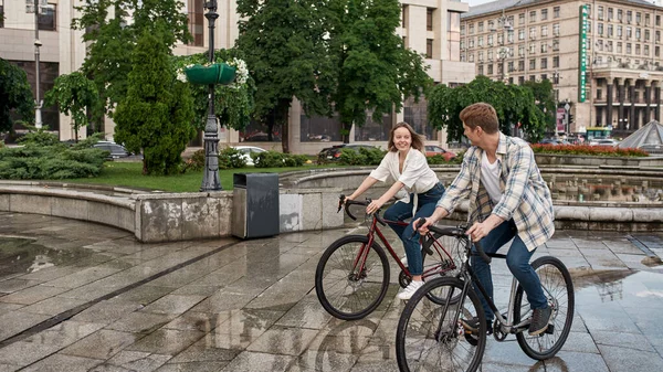 Young Smiling Caucasian Couple Riding Bicycles City Rain Modern Urban — Stock Photo, Image