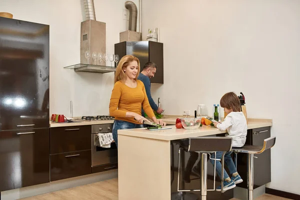 Little Boy Use Digital Tablet While His Mother Father Cook — Stock Photo, Image