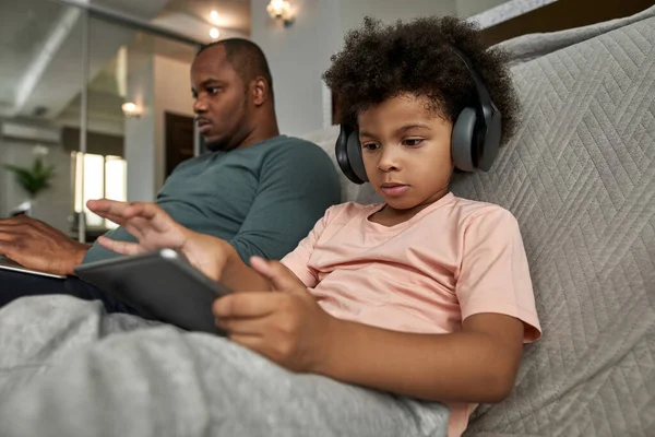 Menino Usando Fones Ouvido Usando Tablet Digital Perto Pai Adulto — Fotografia de Stock